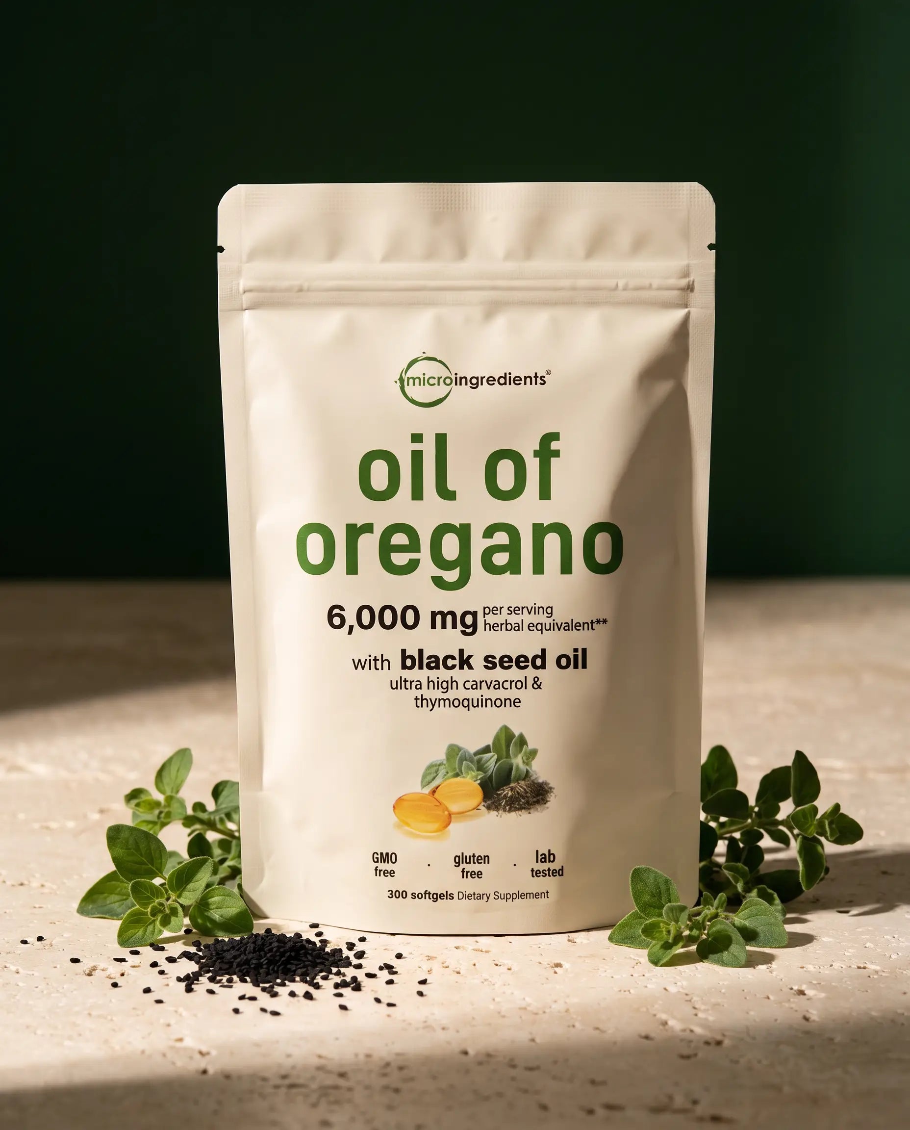 Micro Ingredients Oil of Oregano with Black Seed Oil pouch on a stone surface with fresh oregano